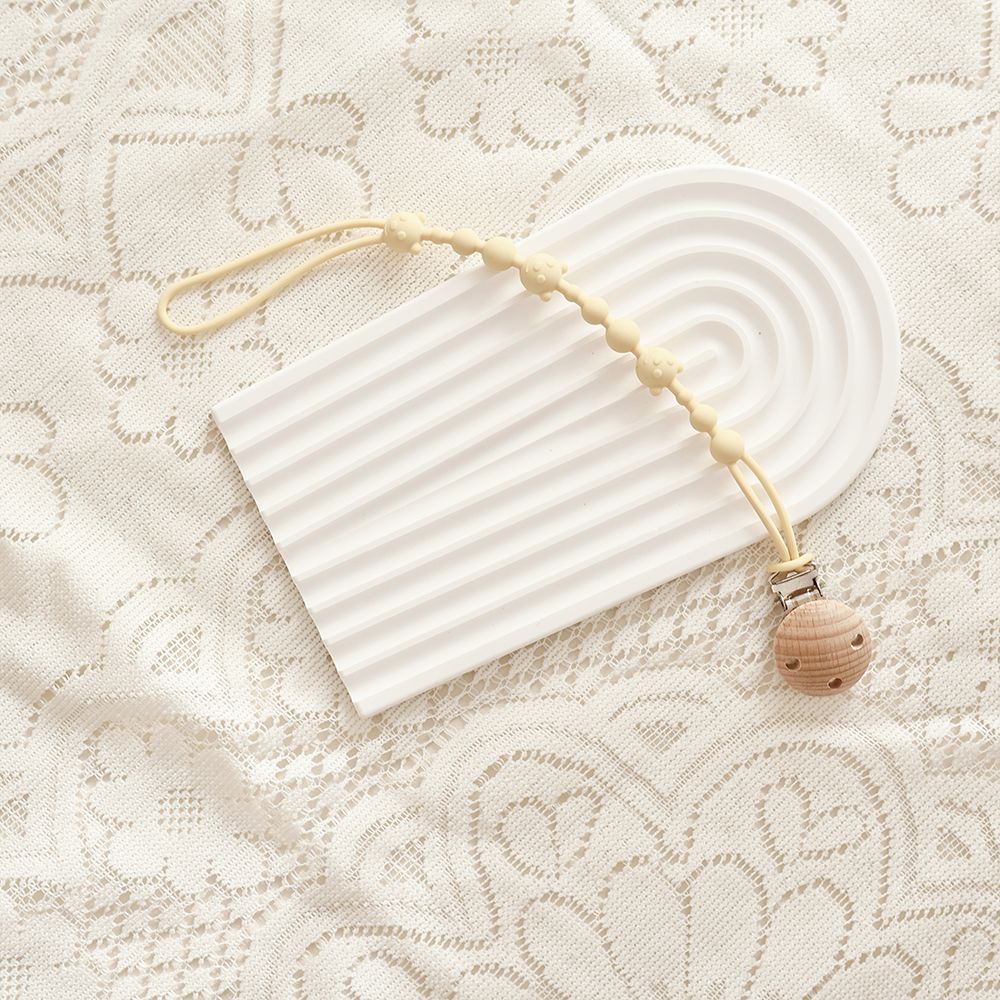 Silicone Dummy Clip, Beaded Soother Holder with Beech Wood Clip & Bear, Face Beads, 22 cm, 7 Colours, styled in a nursery se