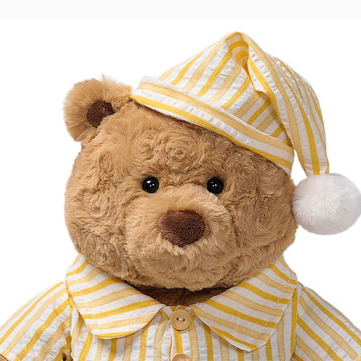 Pajama Teddy Bear Plush Toy, Soft Stuffed Bear in Striped Sleepwear & Cap, 25 cm, held in hand for scale