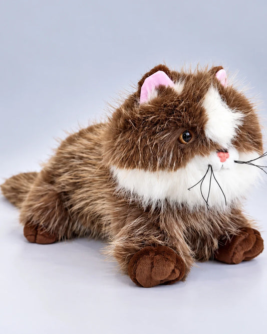 Realistic brown and white Ragdoll-style cat plush toy, lying down, front view