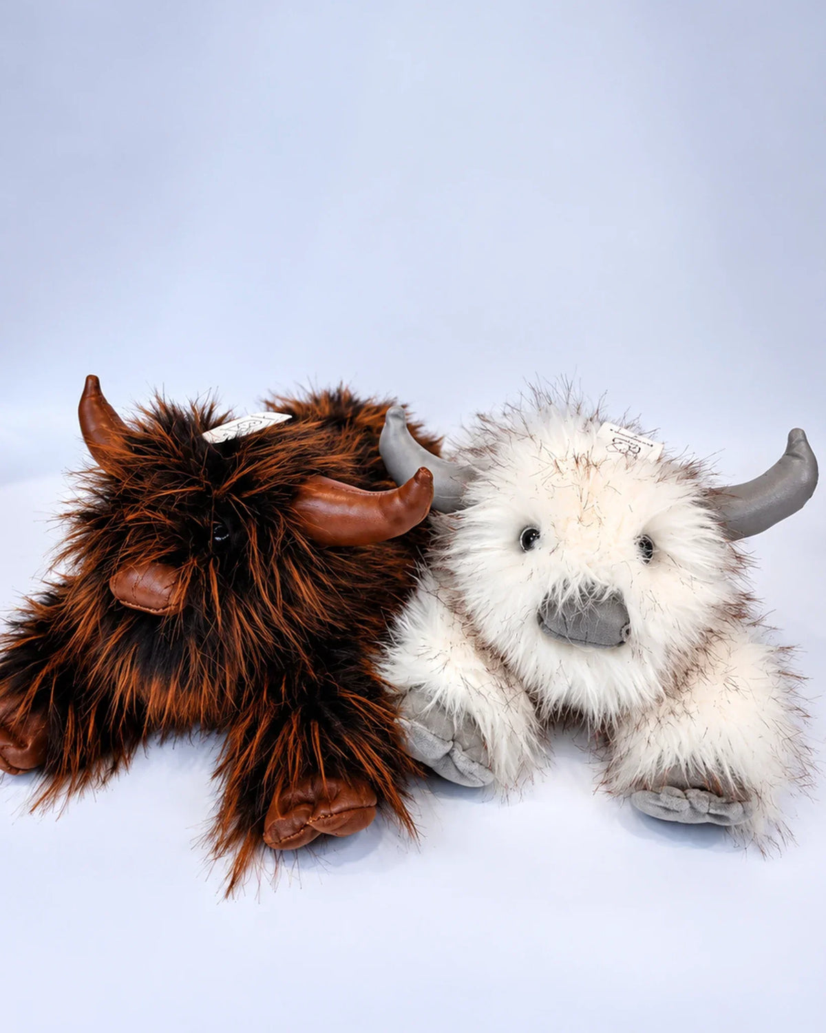 Rustic Brown and Frost White Highland cow plush toys together